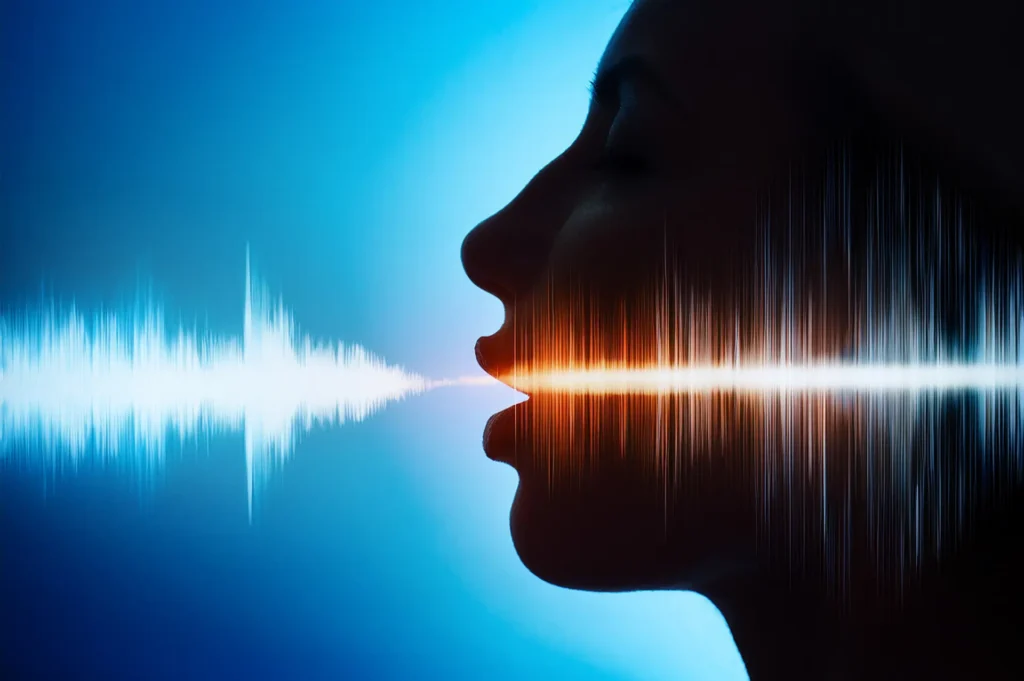 A digital audio waveform on a screen representing voice cloning and synthetic audio generation technology.